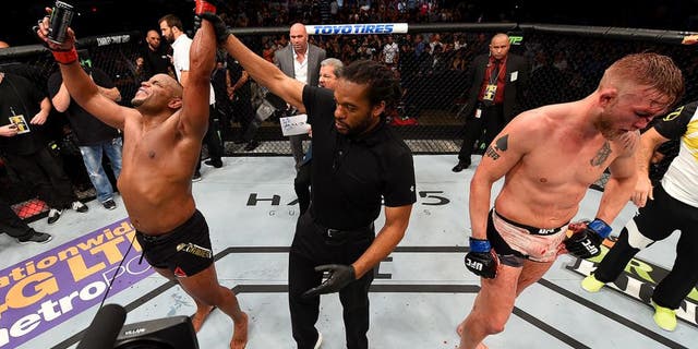 HOUSTON, TX - OCTOBER 03: (L-R) Daniel Cormier celebrates his victory over Alexander Gustafsson in their UFC light heavyweight championship bout during the UFC 192 event at the Toyota Center on October 3, 2015 in Houston, Texas. (Photo by Josh Hedges/Zuffa LLC/Zuffa LLC via Getty Images)