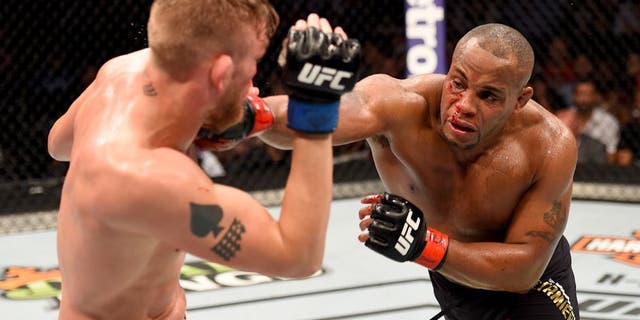 HOUSTON, TX - OCTOBER 03: (R-L) Daniel Cormier punches Alexander Gustafsson in their UFC light heavyweight championship bout during the UFC 192 event at the Toyota Center on October 3, 2015 in Houston, Texas. (Photo by Josh Hedges/Zuffa LLC/Zuffa LLC via Getty Images)