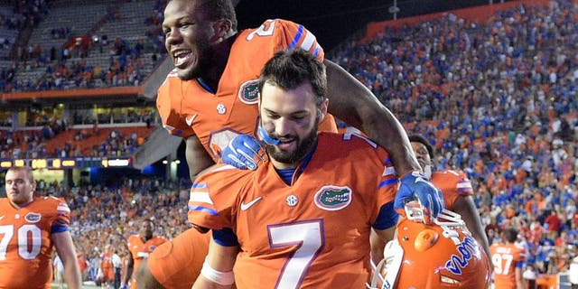 Florida running back Kelvin Taylor celebrates by jumping on quarterback Will Grier (7) after their 38-10 win over Mississippi in an NCAA college football game Saturday, Oct. 3, 2015, in Gainesville, Fla. (AP Photo/Phelan M. Ebenhack)