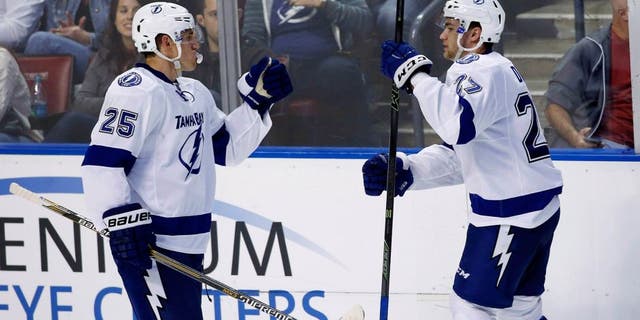 Oct 3, 2015; Sunrise, FL, USA; Tampa Bay Lightning left wing Jonathan Drouin (27) celebrates his game winning goal with defenseman Matt Carle (25) in the third period of a game against the Florida Panthers at BB&T Center. The Lightning won 3-2. Mandatory Credit: Robert Mayer-USA TODAY Sports