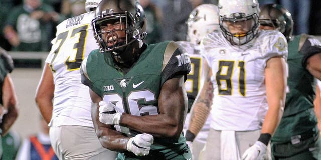 Sep 12, 2015; East Lansing, MI, USA; Michigan State Spartans safety Rj Williamson (26) celebrates goal line stand against the Oregon Ducks during the 1st half of a game at Spartan Stadium. Mandatory Credit: Mike Carter-USA TODAY Sports