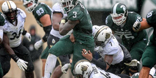 Oct 3, 2015; East Lansing, MI, USA; Michigan State Spartans running back LJ Scott (3) is tackled by Purdue Boilermakers linebacker Andy James Garcia (42) and Purdue Boilermakers safety Robert Gregory (7) during the 2nd half of a game at Spartan Stadium. MSU won 24-21. Mandatory Credit: Mike Carter-USA TODAY Sports