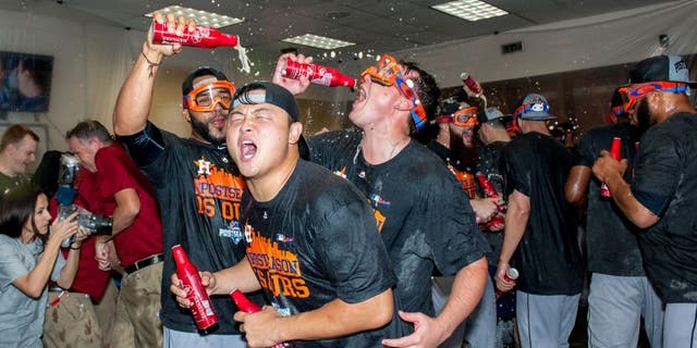 PHOENIX, AZ - OCTOBER 4: Hank Conger #16 of the Houston Astros celebrates with his team after clinching an American League wild card spot after a MLB game against the Arizona Diamondbacks on October 4, 2015 at Chase Field in Phoenix, Arizona. (Photo by Darin Wallentine/Getty Images)