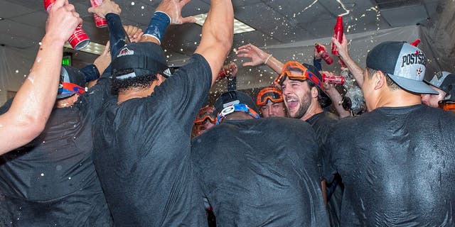 PHOENIX, AZ - OCTOBER 4: Jake Marisnick #6 of the Houston Astros celebrates with his team after clinching a wild card position in the American League playoffs after a MLB game against the Arizona Diamondbacks on October 4, 2015 at Chase Field in Phoenix, Arizona. (Photo by Darin Wallentine/Getty Images)