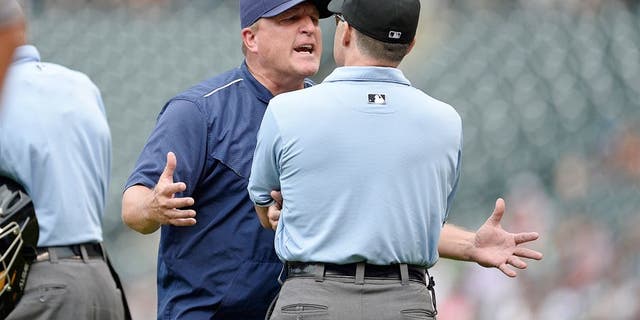 Aug 16, 2015; Denver, CO, USA; San Diego Padres interim manager Pat Murphy (24) argues with third base umpire Dan Iassogna (58) following a replay call in the seventh inning against the Colorado Rockies at Coors Field. The Rockies defeated the Padres 5-0. Mandatory Credit: Ron Chenoy-USA TODAY Sports