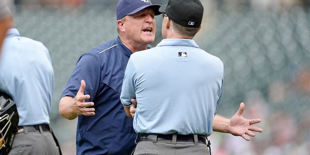 Aug 16, 2015; Denver, CO, USA; San Diego Padres interim manager Pat Murphy (24) argues with third base umpire Dan Iassogna (58) following a replay call in the seventh inning against the Colorado Rockies at Coors Field. The Rockies defeated the Padres 5-0. Mandatory Credit: Ron Chenoy-USA TODAY Sports