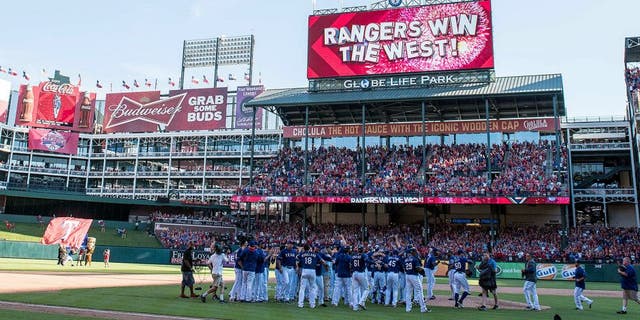 Oct 4, 2015; Arlington, TX, USA; The Texas Rangers celebrate their win over the Los Angeles Angels at Globe Life Park in Arlington. The Texas Rangers defeat the Angels 9-2 and clinch the American League West division. Mandatory Credit: Jerome Miron-USA TODAY Sports