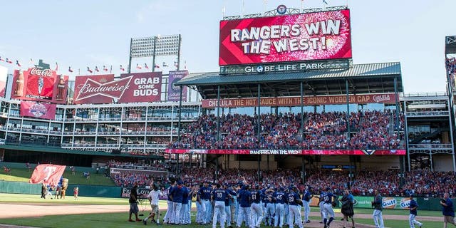 Oct 4, 2015; Arlington, TX, USA; The Texas Rangers celebrate their win over the Los Angeles Angels at Globe Life Park in Arlington. The Texas Rangers defeat the Angels 9-2 and clinch the American League West division. Mandatory Credit: Jerome Miron-USA TODAY Sports