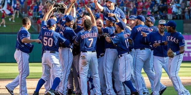 Oct 4, 2015; Arlington, TX, USA; The Texas Rangers celebrate their win over the Los Angeles Angels at Globe Life Park in Arlington. The Texas Rangers defeat the Angels 9-2 and clinch the American League West division. Mandatory Credit: Jerome Miron-USA TODAY Sports