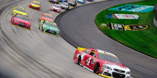 Kevin Harvick, driver of the #4 Budweiser/Jimmy John's Chevrolet, leads a pack of cars during the NASCAR Sprint Cup Series AAA 400 at Dover International Speedway on October 4, 2015 in Dover, Delaware. (Photo by Jeff Curry/Getty Images)
