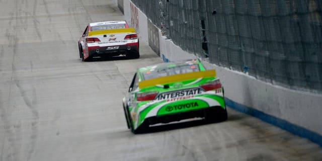 DOVER, DE - OCTOBER 04: Kevin Harvick, driver of the #4 Budweiser/Jimmy John's Chevrolet, leads Kyle Busch, driver of the #18 Interstate Batteries Toyota, during the NASCAR Sprint Cup Series AAA 400 at Dover International Speedway on October 4, 2015 in Dover, Delaware. (Photo by Jeff Curry/Getty Images)