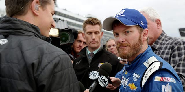 DOVER, DE - OCTOBER 04: Dale Earnrhardt Jr., driver of the #88 Nationwide Plenti Chevrolet, is interviewed on pit road after the NASCAR Sprint Cup Series AAA 400 at Dover International Speedway on October 4, 2015 in Dover, Delaware. Earnhardt Jr. advanced to the next round of the Chase For The Championship. (Photo by Jerry Markland/Getty Images)