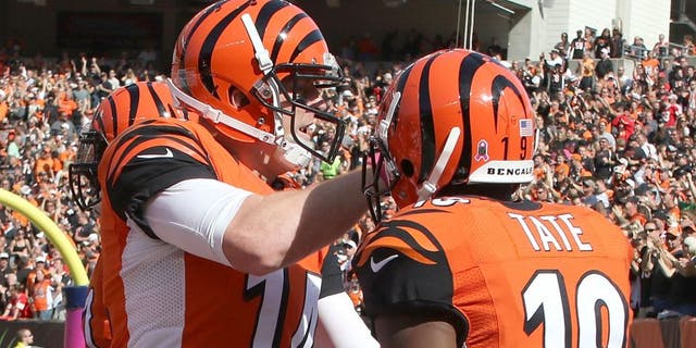 CINCINNATI, OH - OCTOBER 4: Andy Dalton #14 of the Cincinnati Bengals congratulates Brandon Tate #19 of the Cincinnati Bengals after scoring a touchdown on a 55 yard reception during the third quarter of the game against the Kansas City Chiefs at Paul Brown Stadium on October 4, 2015 in Cincinnati, Ohio. (Photo by John Grieshop/Getty Images)