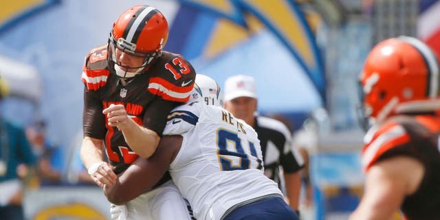 Cleveland Browns quarterback Josh McCown is hit by San Diego Chargers defensive end Kendall Reyes as he throws a pass during the first half in an NFL football game Sunday, Oct. 4, 2015, in San Diego. (AP Photo/Lenny Ignelzi)