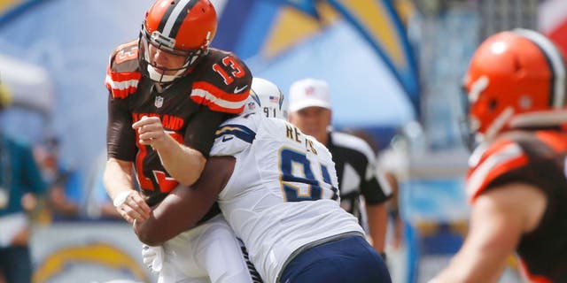 Cleveland Browns quarterback Josh McCown is hit by San Diego Chargers defensive end Kendall Reyes as he throws a pass during the first half in an NFL football game Sunday, Oct. 4, 2015, in San Diego. (AP Photo/Lenny Ignelzi)