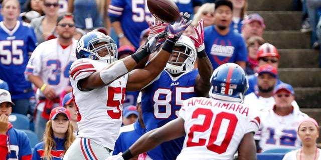 Oct 4, 2015; Orchard Park, NY, USA; New York Giants outside linebacker Devon Kennard (59) intercepts a pass intended for Buffalo Bills tight end Charles Clay (85) during the first half at Ralph Wilson Stadium. Mandatory Credit: Kevin Hoffman-USA TODAY Sports