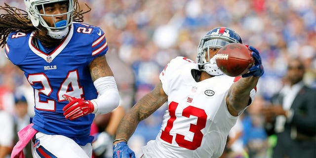 Oct 4, 2015; Orchard Park, NY, USA; New York Giants wide receiver Odell Beckham (13) reaches out but does not make the catch as Buffalo Bills cornerback Stephon Gilmore (24) defends during the first quarter at Ralph Wilson Stadium. Mandatory Credit: Kevin Hoffman-USA TODAY Sports