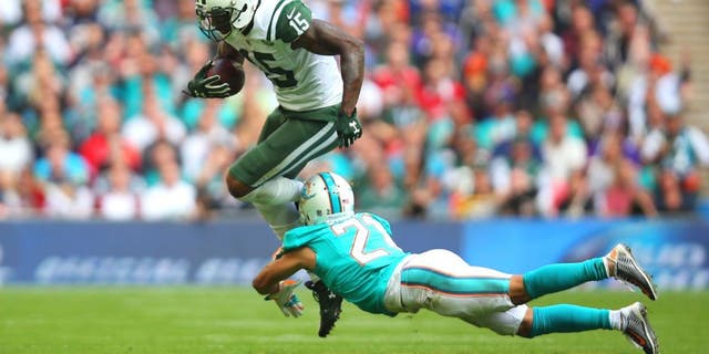 LONDON, ENGLAND - OCTOBER 04: Brandon Marshall #15 of the New York Jets is tackled by Brent Grimes #21 of the Miami Dolphins during the game at Wembley Stadium on October 4, 2015 in London, England. (Photo by Bryn Lennon/Getty Images)