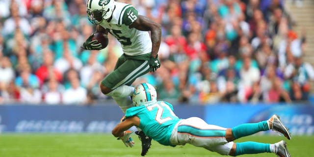 LONDON, ENGLAND - OCTOBER 04: Brandon Marshall #15 of the New York Jets is tackled by Brent Grimes #21 of the Miami Dolphins during the game at Wembley Stadium on October 4, 2015 in London, England. (Photo by Bryn Lennon/Getty Images)
