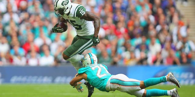 LONDON, ENGLAND - OCTOBER 04: Brandon Marshall #15 of the New York Jets is tackled by Brent Grimes #21 of the Miami Dolphins during the game at Wembley Stadium on October 4, 2015 in London, England. (Photo by Bryn Lennon/Getty Images)