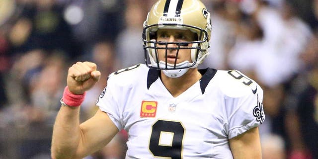 Oct 4, 2015; New Orleans, LA, USA; New Orleans Saints quarterback Drew Brees (9) celebrates after a touchdown pass against the Dallas Cowboys during the first quarter at the Mercedes-Benz Superdome. Mandatory Credit: Derick E. Hingle-USA TODAY Sports