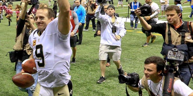 Oct 4, 2015; New Orleans, LA, USA; New Orleans Saints quarterback Drew Brees (9) walks off the field after a 80 yard game winning touchdown pass to running back C.J. Spiller (not pictured) during overtime against the Dallas Cowboys at the Mercedes-Benz Superdome. The Saints won 26-20. The touchdown pass by Brees was the 400th touchdown pass of his career. Mandatory Credit: Derick E. Hingle-USA TODAY Sports