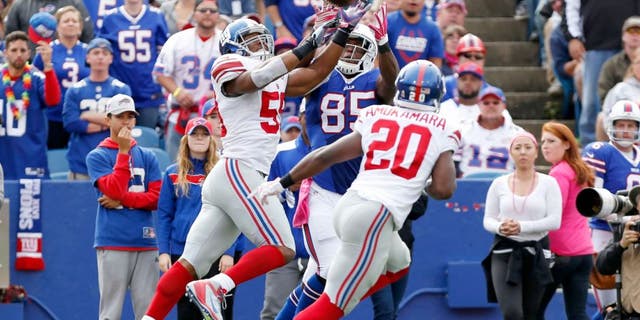Oct 4, 2015; Orchard Park, NY, USA; New York Giants outside linebacker Devon Kennard (59) intercepts a pass intended for Buffalo Bills tight end Charles Clay (85) during the first half at Ralph Wilson Stadium. Mandatory Credit: Kevin Hoffman-USA TODAY Sports