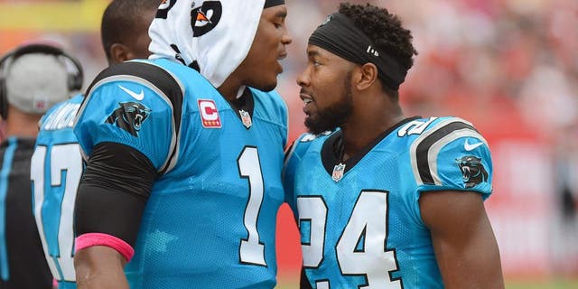 Oct 4, 2015; Tampa, FL, USA; Carolina Panthers defensive back Josh Norman (24) celebrates with Carolina Panthers quarterback Cam Newton (1) after a interception return for touchdown in the first half against the Tampa Bay Buccaneers at Raymond James Stadium. Mandatory Credit: Jonathan Dyer-USA TODAY Sports