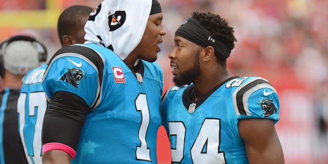 Oct 4, 2015; Tampa, FL, USA; Carolina Panthers defensive back Josh Norman (24) celebrates with Carolina Panthers quarterback Cam Newton (1) after a interception return for touchdown in the first half against the Tampa Bay Buccaneers at Raymond James Stadium. Mandatory Credit: Jonathan Dyer-USA TODAY Sports