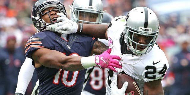 CHICAGO, IL - OCTOBER 04: Charles Woodson #24 of the Oakland Raiders breaks way from Marquess Wilson #10 of the Chicago Bears after intercepting a pass in the 4th quarter at Soldier Field on October 4, 2015 in Chicago, Illinois. The Bears defeated the Raiders 22-20. (Photo by Jonathan Daniel/Getty Images)