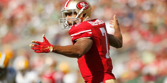 Oct 4, 2015; Santa Clara, CA, USA; San Francisco 49ers quarterback Colin Kaepernick (7) reacts after being hit on a 49ers running play against the Green Bay Packers in the third quarter at Levi's Stadium. The Packers defeated the 49ers 17-3. Mandatory Credit: Cary Edmondson-USA TODAY Sports
