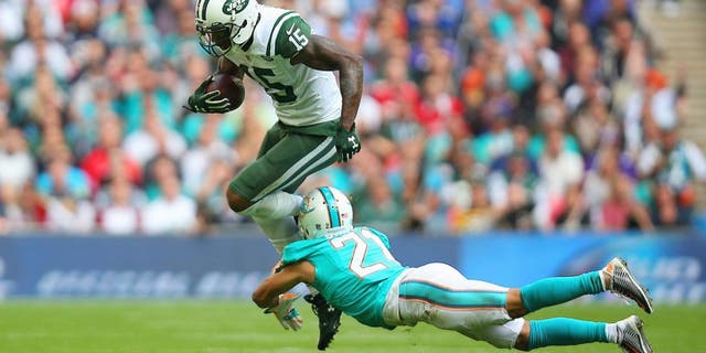 LONDON, ENGLAND - OCTOBER 04: Brandon Marshall #15 of the New York Jets is tackled by Brent Grimes #21 of the Miami Dolphins during the game at Wembley Stadium on October 4, 2015 in London, England. (Photo by Bryn Lennon/Getty Images)