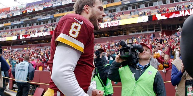 Oct 4, 2015; Landover, MD, USA; Washington Redskins quarterback Kirk Cousins (8) celebrates while leaving the field after the Reskins' game against the Philadelphia Eagles at FedEx Field. The Redskins won 23-20. Mandatory Credit: Geoff Burke-USA TODAY Sports