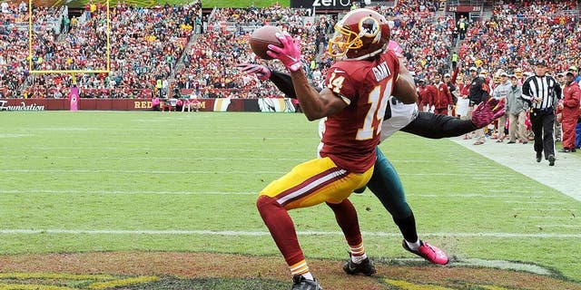 Oct 4, 2015; Landover, MD, USA; Washington Redskins wide receiver Ryan Grant (14) is interfered with by Philadelphia Eagles cornerback Eric Rowe (32) during the first half at FedEx Field. Mandatory Credit: Brad Mills-USA TODAY Sports
