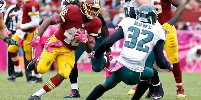 Oct 4, 2015; Landover, MD, USA; Washington Redskins running back Alfred Morris (46) carries the ball as Philadelphia Eagles cornerback Eric Rowe (32) attempts the tackle in the fourth quarter at FedEx Field. The Redskins won 23-20. Mandatory Credit: Geoff Burke-USA TODAY Sports