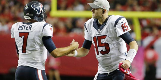 Houston Texans quarterback Ryan Mallett (15) congratulates Houston Texans quarterback Brian Hoyer (7) after Hoyer through a touchdown passs against the Atlanta Falcons during the second half of an NFL football game, Sunday, Oct. 4, 2015, in Atlanta. (AP Photo/David Goldman)