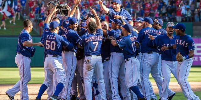 Oct 4, 2015; Arlington, TX, USA; The Texas Rangers celebrate their win over the Los Angeles Angels at Globe Life Park in Arlington. The Texas Rangers defeat the Angels 9-2 and clinch the American League West division. Mandatory Credit: Jerome Miron-USA TODAY Sports
