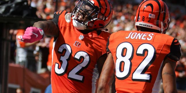Cincinnati Bengals running back Jeremy Hill (32) celebrates after scoring a touchdown in the first half of a NFL football game against the Kansas City Chiefs, Sunday, Oct. 4, 2015, in Cincinnati. (AP Photo/Frank Victores)