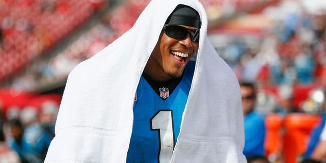Oct 4, 2015; Tampa, FL, USA; Carolina Panthers quarterback Cam Newton (1) has a laugh with teammates on the side line during the fourth quarter of an NFL football game against the Tampa Bay Buccaneers at Raymond James Stadium. Carolina won 37-23. Mandatory Credit: Reinhold Matay-USA TODAY Sports