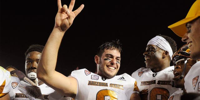 PASADENA, CA - OCTOBER 3: Quarterback Mike Bercovici #2 of the Arizona State Sun Devils and teammate celebrate the upset win over UCLA Bruins, 38-23, at the Rose Bowl October 3, 2015, in Pasadena, California. (Photo by Kevork Djansezian/Getty Images)