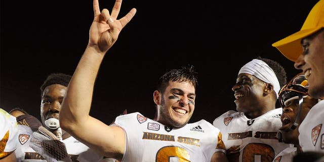PASADENA, CA - OCTOBER 3: Quarterback Mike Bercovici #2 of the Arizona State Sun Devils and teammate celebrate the upset win over UCLA Bruins, 38-23, at the Rose Bowl October 3, 2015, in Pasadena, California. (Photo by Kevork Djansezian/Getty Images)