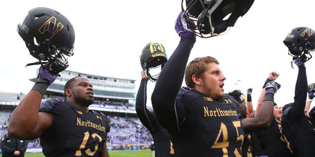 Oct 3, 2015; Evanston, IL, USA; Northwestern Wildcats defensive lineman Deonte Gibson (13) celebrates with teammates after defeating the Minnesota Golden Gophers at Ryan Field. Mandatory Credit: Caylor Arnold-USA TODAY Sports