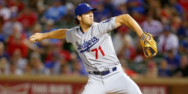 ARLINGTON, TX - JUNE 16: Josh Ravin #71 of the Los Angeles Dodgers pitches in the ninth inning during a game against the Texas Rangers at Globe Life Park in Arlington on June 16, 2015 in Arlington, Texas. The Texas Rangers defeated the Los Angeles Dodgers 3-2. (Photo by Sarah Crabill/Getty Images)