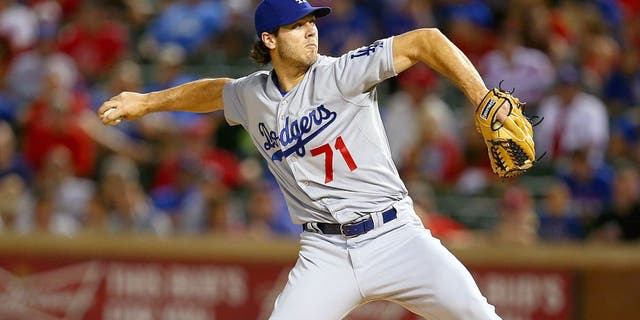 ARLINGTON, TX - JUNE 16: Josh Ravin #71 of the Los Angeles Dodgers pitches in the ninth inning during a game against the Texas Rangers at Globe Life Park in Arlington on June 16, 2015 in Arlington, Texas. The Texas Rangers defeated the Los Angeles Dodgers 3-2. (Photo by Sarah Crabill/Getty Images)