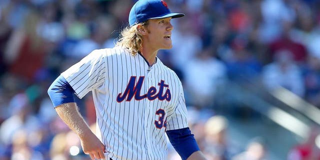 NEW YORK, NY - SEPTEMBER 19: Noah Syndergaard #34 of the New York Mets reacts in the sixth inning against the New York Yankees during interleague play on September 19, 2015 at Citi Field in the Flushing neighborhood of the Queens borough of New York City. (Photo by Elsa/Getty Images)
