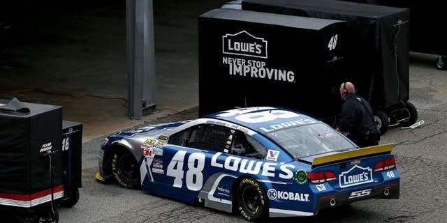 DOVER, DE - OCTOBER 04: Jimmie Johnson, driver of the #48 Lowe's Chevrolet, drives into his garage during the NASCAR Sprint Cup Series AAA 400 at Dover International Speedway on October 4, 2015 in Dover, Delaware. (Photo by Patrick Smith/Getty Images)