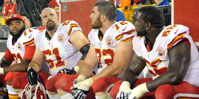 Sep 28, 2015; Green Bay, WI, USA; Kansas City Chiefs offensive tackle Jeff Allen (71), center Mitch Morse (61), offensive tackle Eric Fisher (72) and guard Ben Grubbs (66) watch the final minutes of the game against the Green Bay Packers at Lambeau Field. Mandatory Credit: Benny Sieu-USA TODAY Sports