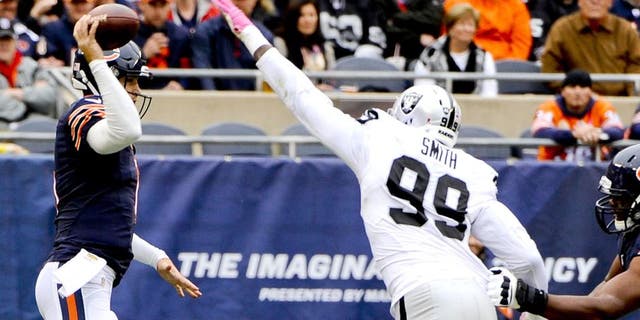Oct 4, 2015; Chicago, IL, USA; Oakland Raiders outside linebacker Aldon Smith (99) tips the ball after Chicago Bears quarterback Jay Cutler (6) throws in the first quarter at Soldier Field. Mandatory Credit: Matt Marton-USA TODAY Sports