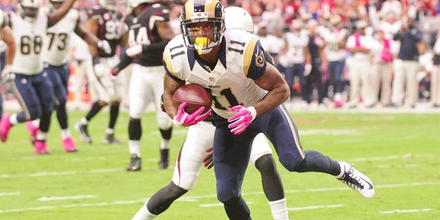 Oct 4, 2015; Glendale, AZ, USA; St. Louis Rams wide receiver Tavon Austin (11) breaks a tackle from Arizona Cardinals free safety Tyrann Mathieu (32) to score a 12 yard touchdown during the first half at University of Phoenix Stadium. Mandatory Credit: Matt Kartozian-USA TODAY Sports