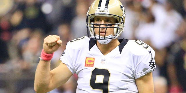 Oct 4, 2015; New Orleans, LA, USA; New Orleans Saints quarterback Drew Brees (9) celebrates after a touchdown pass against the Dallas Cowboys during the first quarter at the Mercedes-Benz Superdome. Mandatory Credit: Derick E. Hingle-USA TODAY Sports